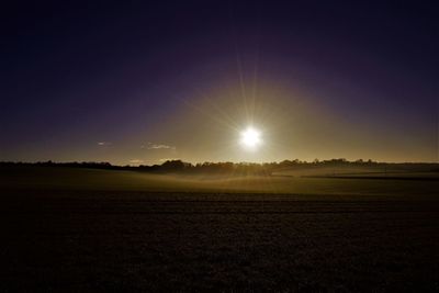 Scenic view of field against sky during sunset