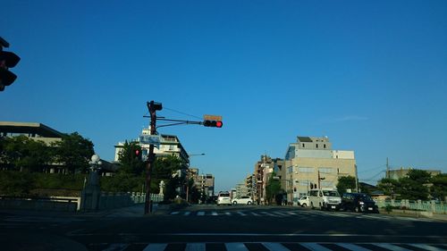 View of city street against blue sky