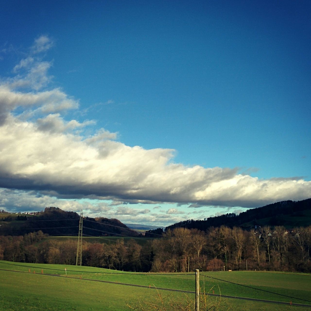 landscape, mountain, sky, tranquil scene, tranquility, scenics, grass, field, blue, mountain range, beauty in nature, nature, tree, non-urban scene, cloud, cloud - sky, grassy, countryside, built structure, green color