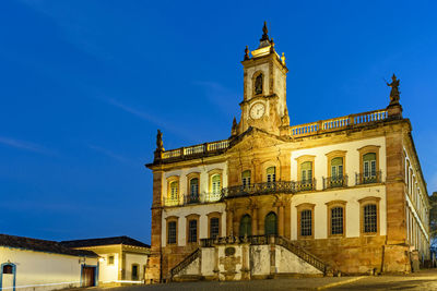 Low angle view of historical building against blue sky