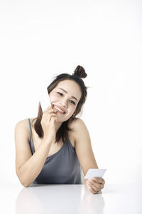 Portrait of a smiling young woman over white background