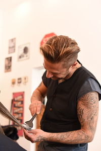 Smiling barber working in shop