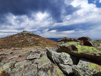 Low angle view of rocks on mountain against sky