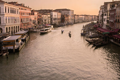 Boats in canal against buildings in city