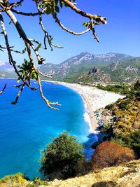 Scenic view of sea and mountains against sky