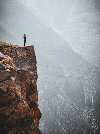 Men standing on rock mountain 