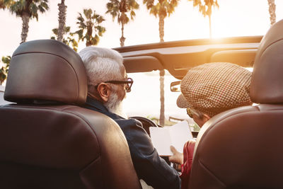 Rear view of man and woman in car