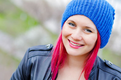 Young beautiful girl with bright hair in spring park