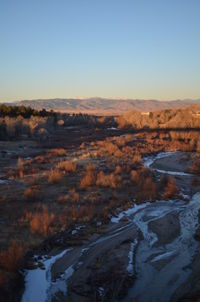 Scenic view of landscape against clear sky during winter