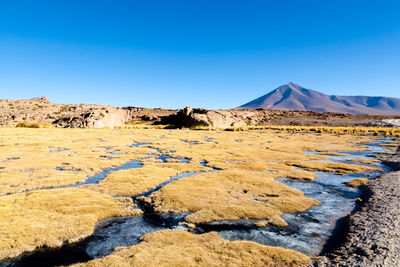 Scenic view of rocky mountains against clear blue sky