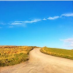 Empty road along landscape