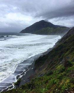 Scenic view of sea against cloudy sky