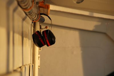 Close-up of red headphones on wall