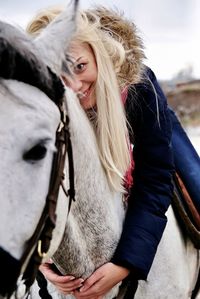 Portrait of happy woman riding the horse