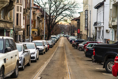 Vehicles on road amidst buildings in city