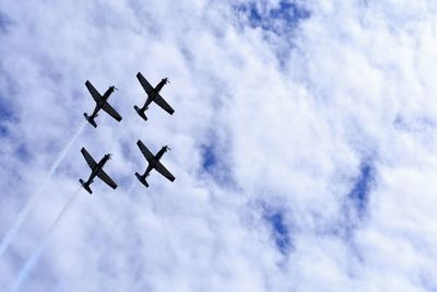 Low angle view of airplane flying against sky