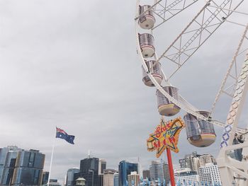 Low angle view of flags hanging against sky