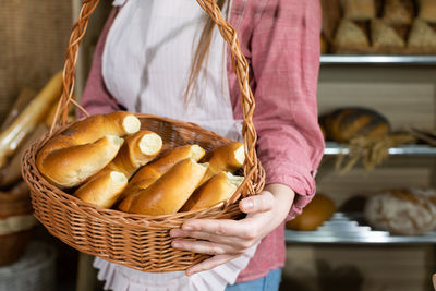 Midsection of woman holding wicker basket