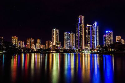 Illuminated city at waterfront
