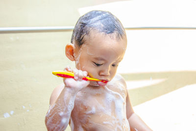 Cute boy eating food in water