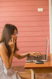 The little girl was playing a laptop and was calling with her friends.