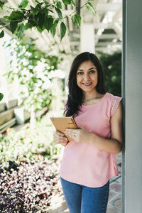 Corporate portrait of a beautiful agronomical engineer in a greenhouse