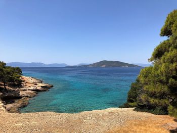 Scenic view of sea against clear blue sky