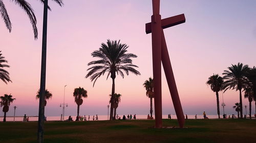 Silhouette palm trees against sky during sunset