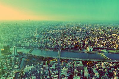 Aerial view of cityscape against sky during sunset