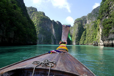 Boat in river with mountain in background