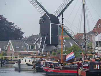 Boats in canal against sky