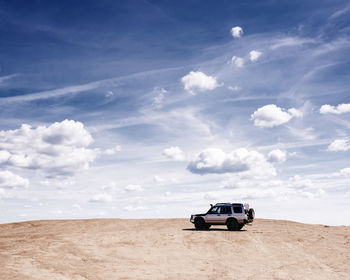 View of car on desert land