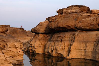 Low angle view of rock formation against sky