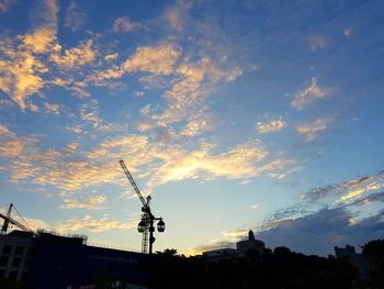 Low angle view of silhouette buildings against sky during sunset