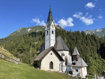 Church amidst buildings against sky