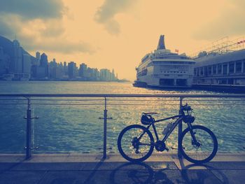 Cars parked in front of building against sky at sunset