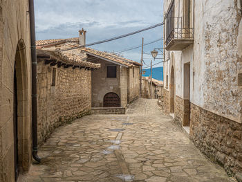 Alley amidst buildings against sky