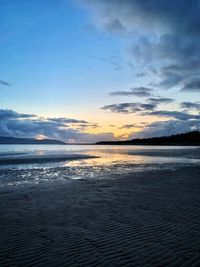 Scenic view of beach against sky during sunset