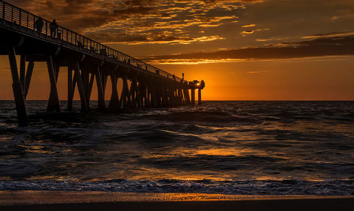 View of pier over sea against cloudy sky