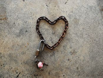 High angle view of heart shape chain on footpath