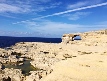 Old ruins at beach against blue sky