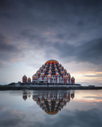 Reflection of building in lake at sunset