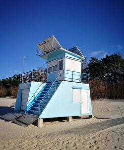 Lifeguard hut on beach against clear sky