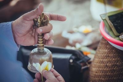 Close-up of hand holding bell