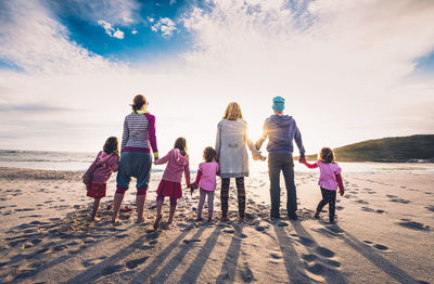 People on beach against sky