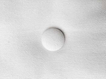 Close-up of button on white fabric