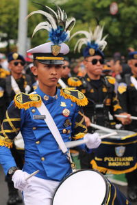 A man playing drum in a marching band