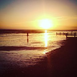 Scenic view of beach against sky during sunset