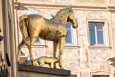 Statue of horse in front of  historic building