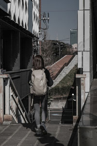 Full length of young woman standing in city